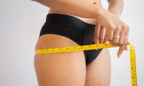 woman measuring waist