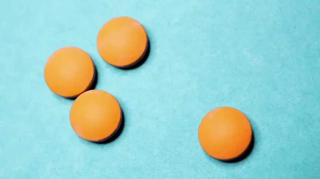Orange Levitra Pills on blue background