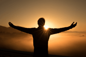 man looking at sunrise